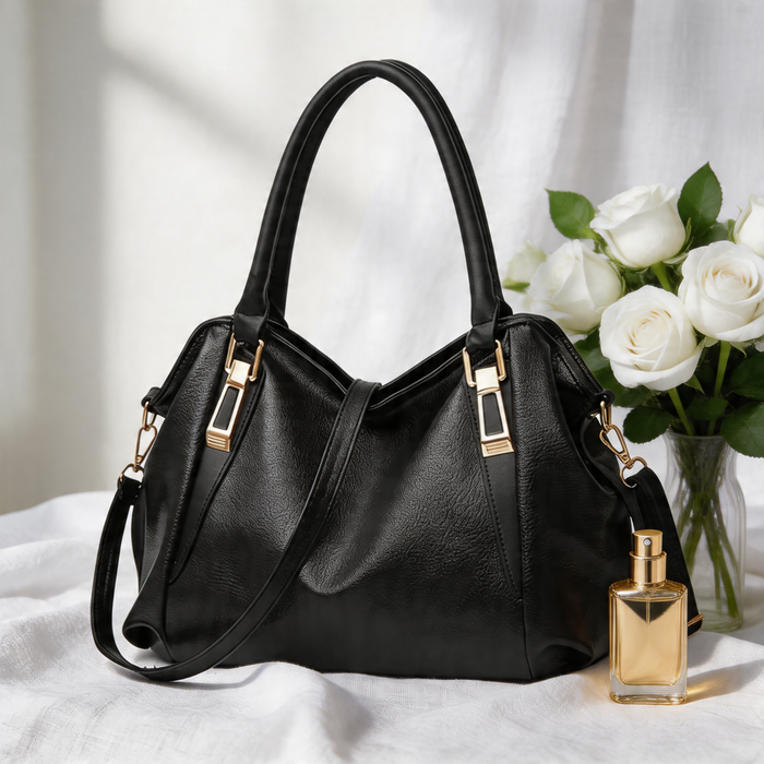 Large black pebbled leather women's tote handbag with dual top handles, gold-tone metal hardware, and removable adjustable shoulder strap