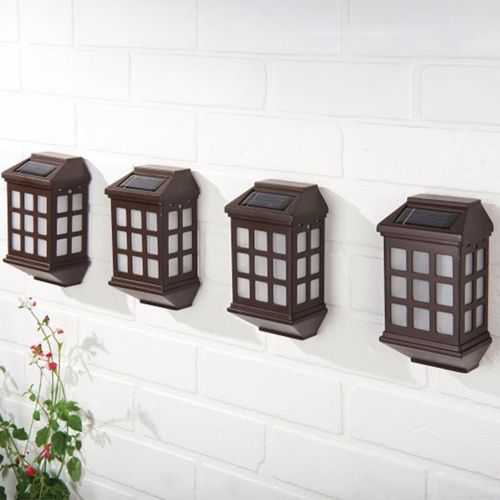 Set of four LED solar lights for outdoor mounting, providing ambient warm light for fences, walls, and steps.