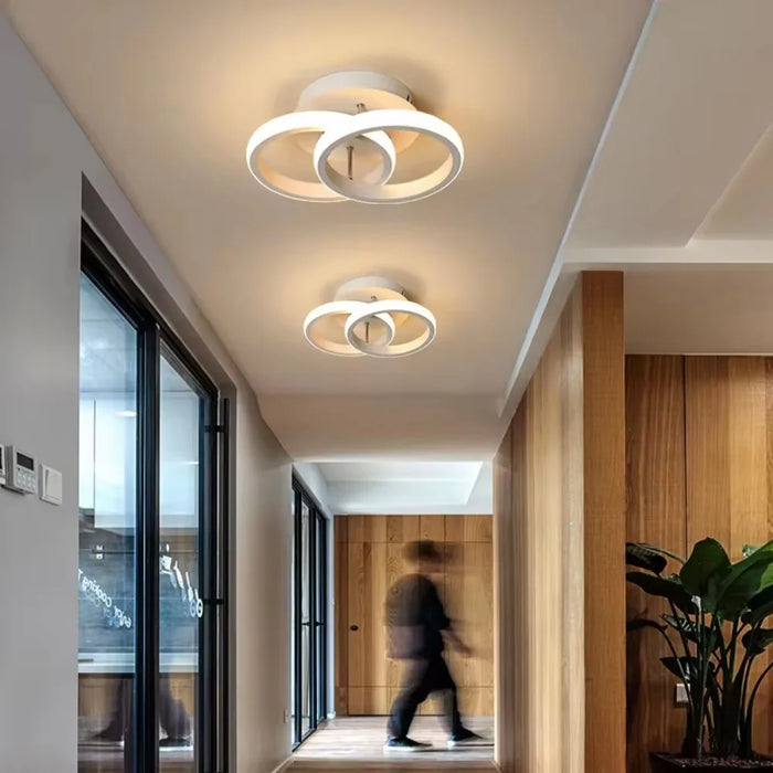 Modern round LED ceiling light with black aluminum body and acrylic shade