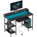 Black ergonomic workstation desk with RGB lights, USB-C ports, and storage shelves