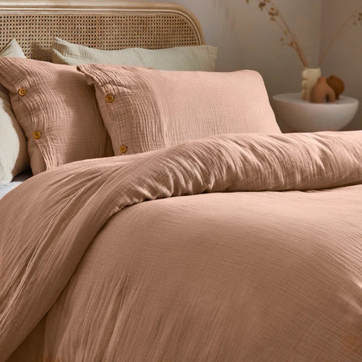 duvet cover set in pastel tones with wooden button closure, showcasing modern crinkle texture and breathable fabric.