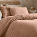 duvet cover set in pastel tones with wooden button closure, showcasing modern crinkle texture and breathable fabric.