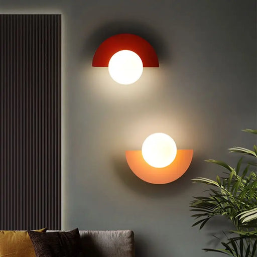 Art Deco black and gold wall sconce with plastic ball design mounted on wall