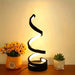 Modern spiral LED table lamp with 3-color dimmable lighting on a bedside table
