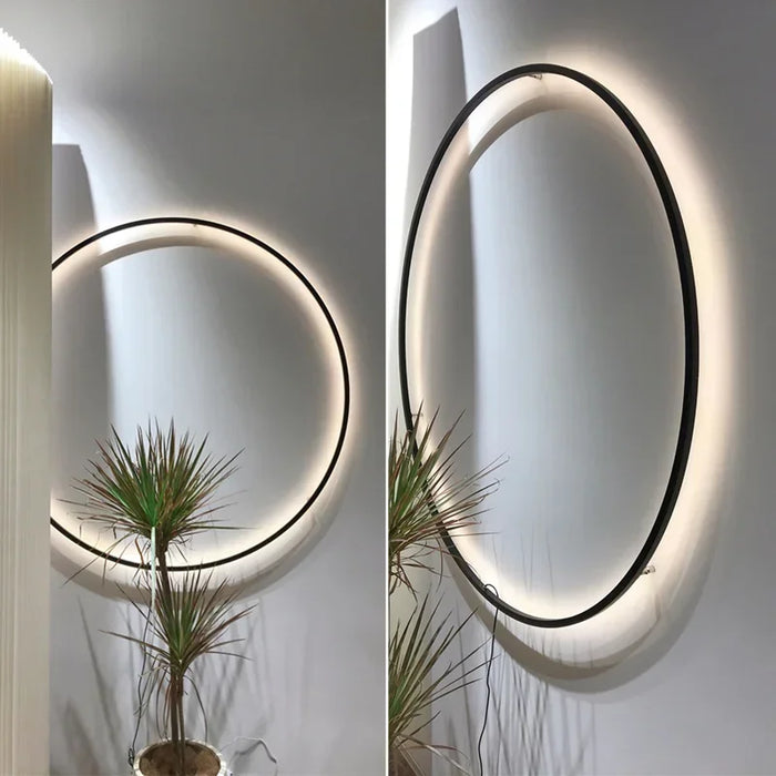 Modern USB-powered LED ring wall lamp mounted on a white interior wall, emitting soft ambient light for bedrooms and living spaces