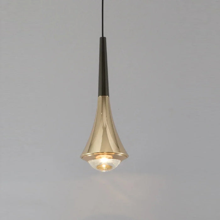 Modern aluminum pendant light hanging over a stylish dining space