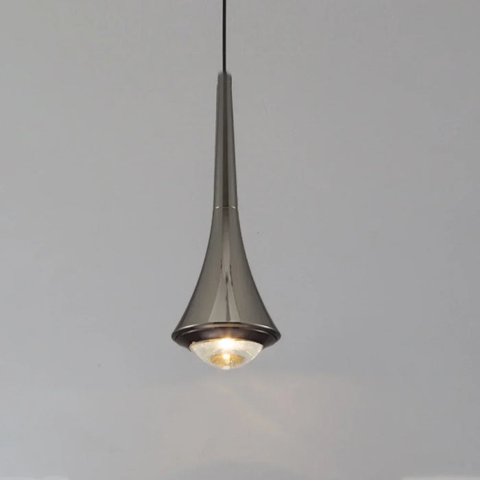Modern aluminum pendant light hanging over a stylish dining space