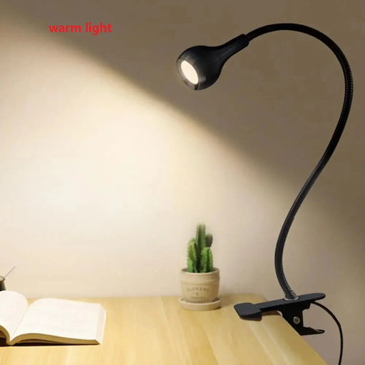 USB LED book light with flexible clip holder for adjustable lighting, ideal for reading and study.