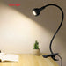 USB LED book light with flexible clip holder for adjustable lighting, ideal for reading and study.