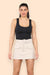 Woman wearing khaki belted cargo skort with utility pockets