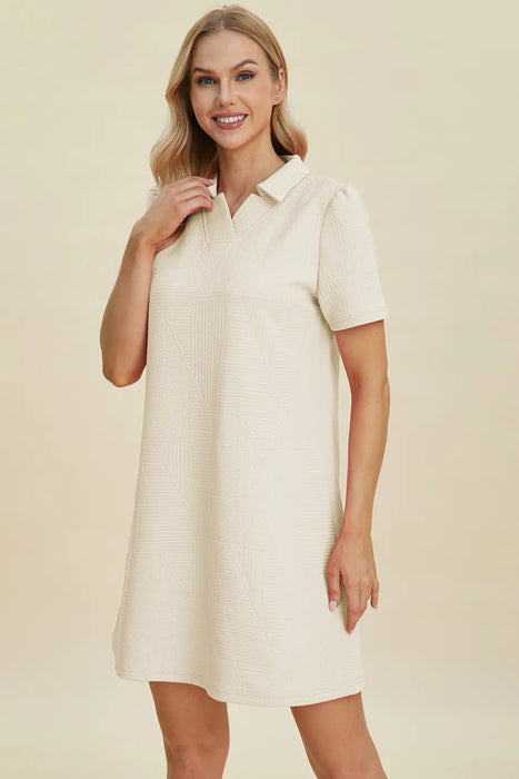 Woman wearing a textured short sleeve midi dress in a relaxed pose, perfect for casual and stylish looks