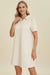 Woman wearing a textured short sleeve midi dress in a relaxed pose, perfect for casual and stylish looks