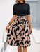 Woman wearing printed mock neck short sleeve dress with tie detail