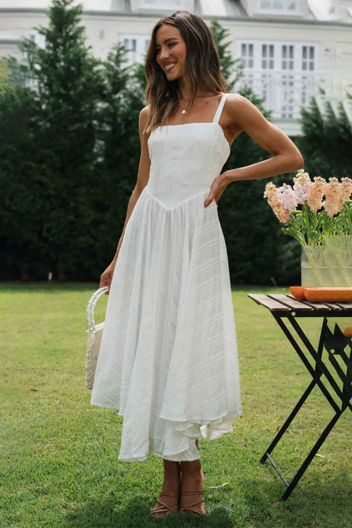 Woman wearing 100% cotton dress with wide straps and ruffle details for summer