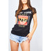 Woman wearing a black slim-fit Brooklyn tee with East Side print, styled with high-waisted jeans in natural lighting.