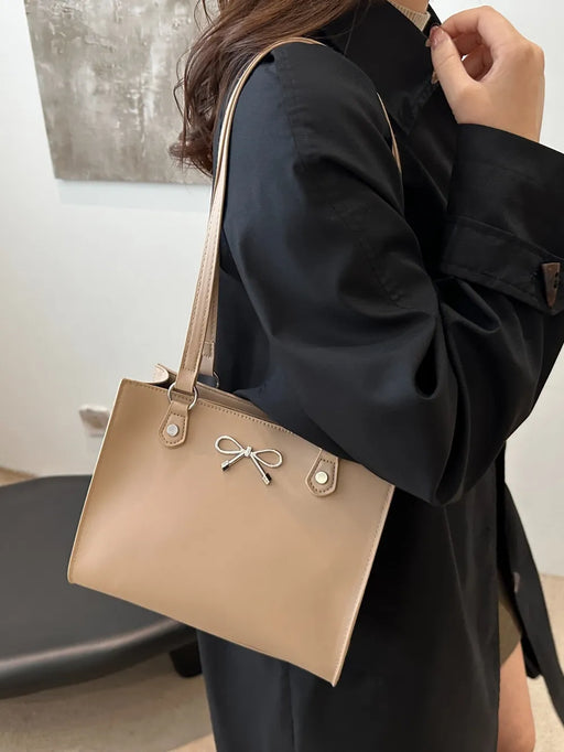 Medium-sized PU leather handbag with a structured design in neutral tones