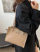 Medium-sized PU leather handbag with a structured design in neutral tones