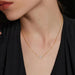 Close-up of a 0.5 carat Moissanite pendant necklace with a gold-plated chain on display

