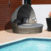 4-piece outdoor rattan daybed set with canopy and cushions on a garden patio

