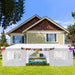 Large white 10x30 outdoor party tent with sidewalls and windows set up in a backyard