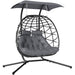 Double rattan swing chair with canopy, cushions, and steel frame for outdoor garden or patio use

