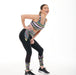 Model wearing Aso-Oke pastel print leggings with a high-compression waistband